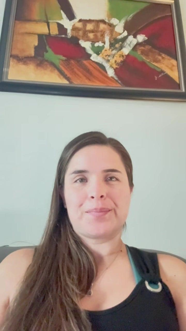 Woman seated beneath an abstract painting in a video thumbnail
