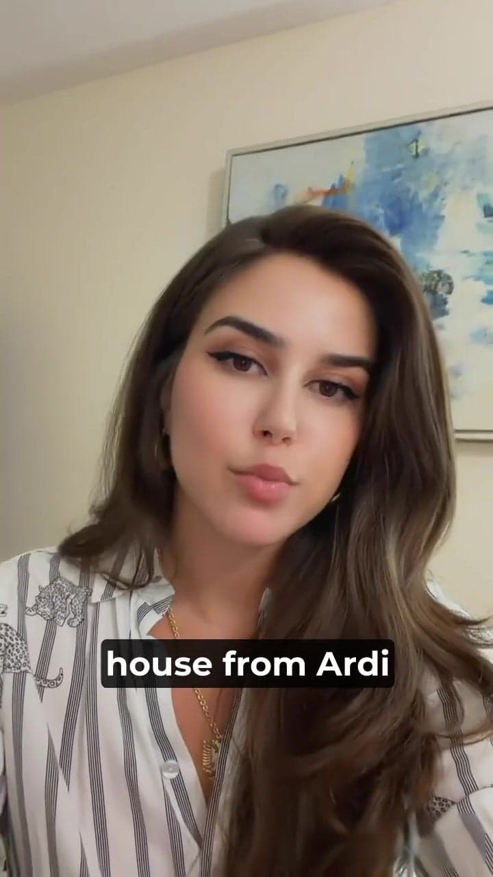 Woman in a striped blouse speaking to the camera